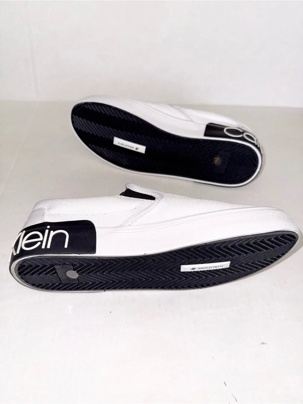 Calvin Klein White Canvas Slip-On Loafers with Black Heel Logo Accent